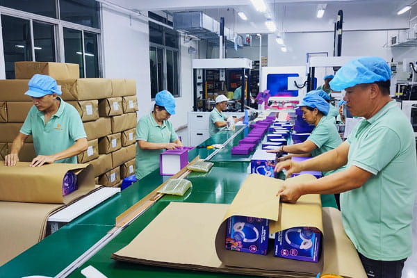 Packing a finished batch of boxes at a factory in China