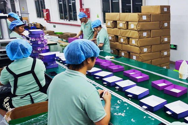 Manual assembly of gift boxes at a packaging factory in China